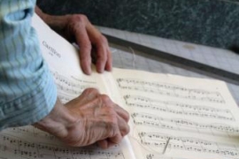 Music librarians mend aged sheet music. 